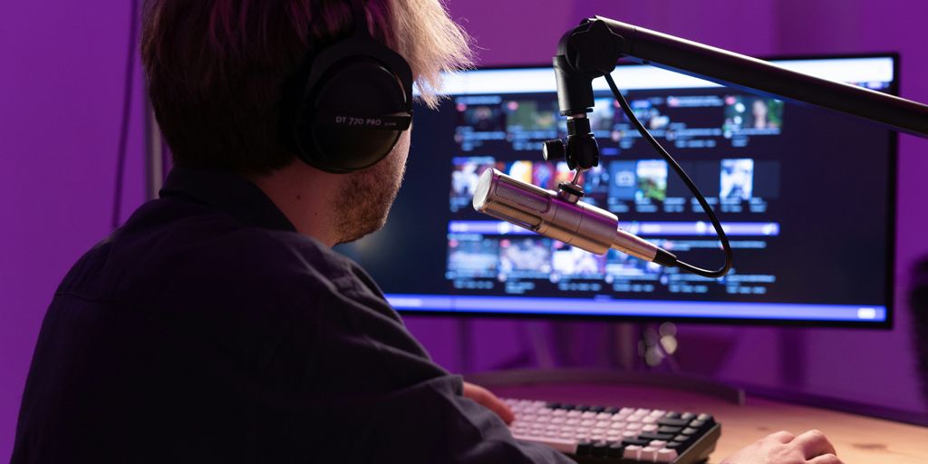 a man wearing a virtual reality headset and playing a keyboard