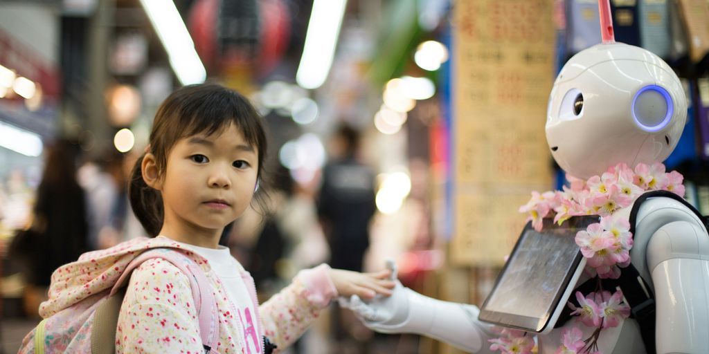 photo of girl laying left hand on white digital robot