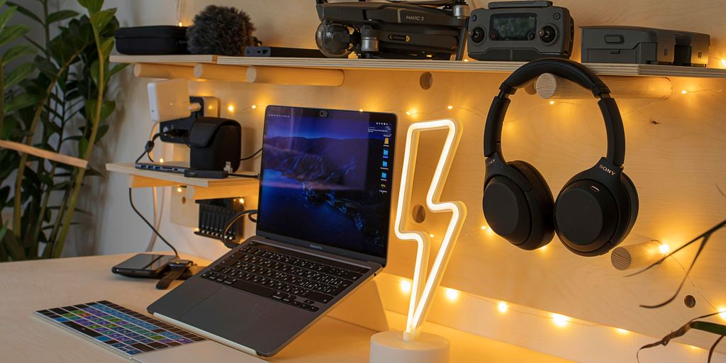 black and silver laptop computer beside black and gray headphones