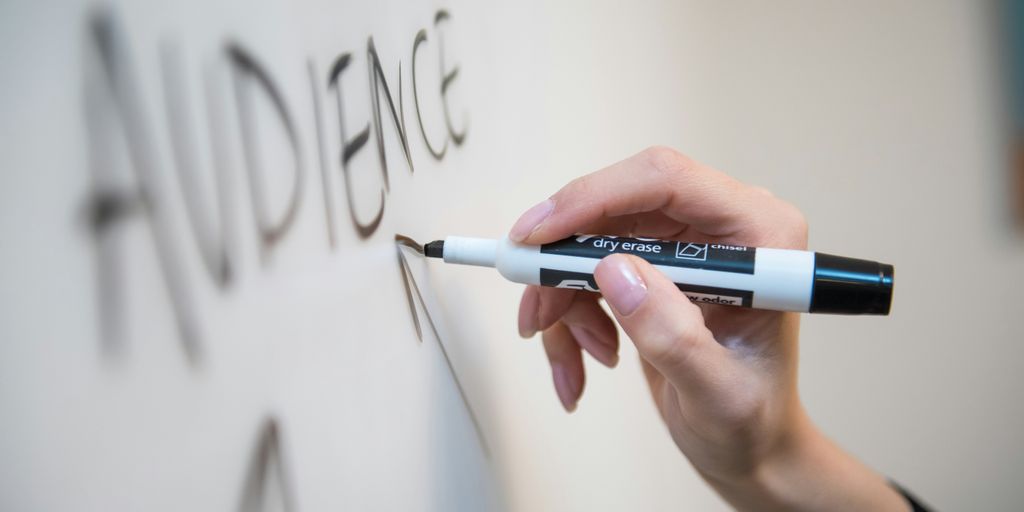 person holding white and blue click pen